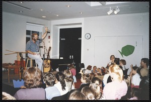 Newton Free Library, Newton, MA. Communications & Programs Office. Singer-story-teller in Druker Auditorium