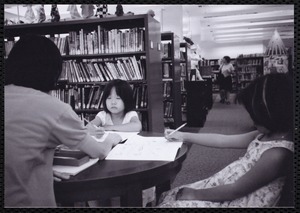 Newton Free Library, Newton, MA. Communications & Programs Office. Young girls studying in a library