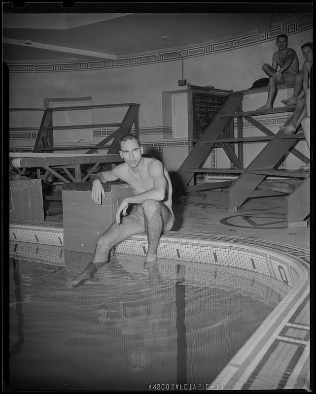 Springfield College swimmer sitting at edge of pool - Digital Commonwealth