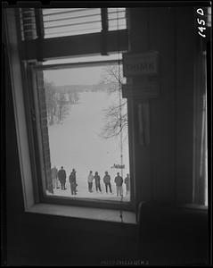 Students outside seen through a window