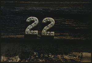 Number 22 attached to piece of wood