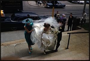 Bride walking up steps from sidewalk, Jamaica Plain, Massachusetts