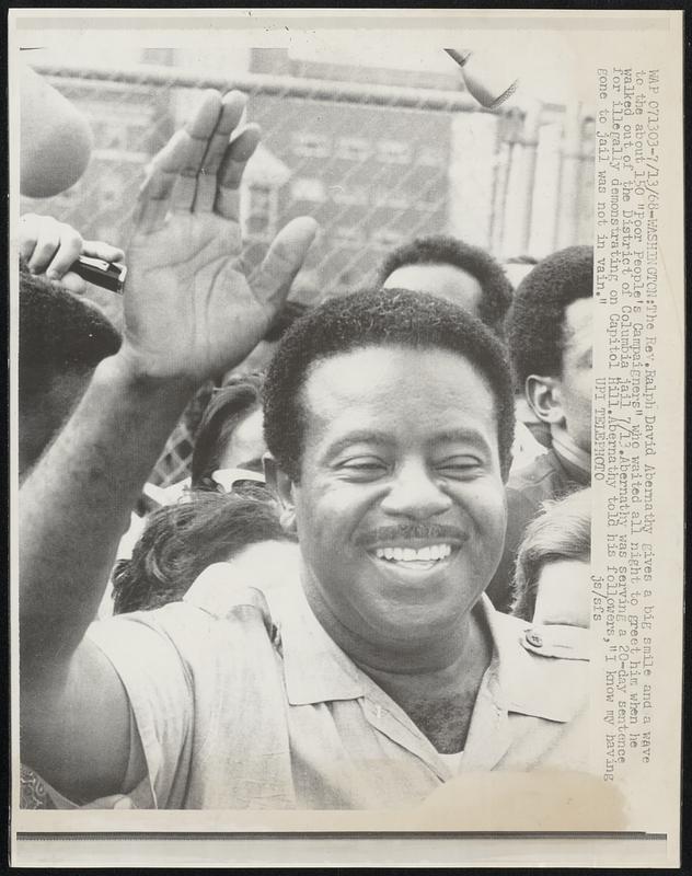 The Rev. Ralph David Abernathy gives a big smile and a wave to the about 150 "Poor People's Campaigners" who waited all night to greet him when he walked out of the District of Columbia jail 7/13. Abernathy was serving a 20-day sentence for illegally demonstrating on Capitol Hill. Abernathy told his followers, "I know my having gone to jail was not in vain."