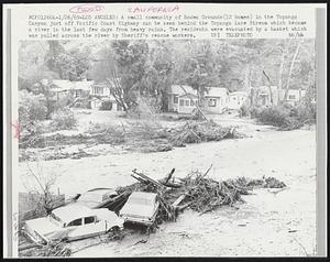 A small community of Rodeo Grounds (12 homes) in the Topanga Canyon just off Pacific Coast Highway can be seen behind the Topanga Lane Stream which became a river in the last few days from heavy rains. The residents were evacuated by a basket which was pulled across the river by Sheriff's rescue workers.