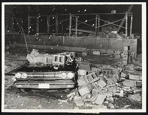 Collapsed Wall of warehouse in Needham Heights crushed car during storm last night.