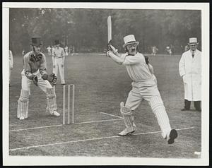 It’s Hardly Cricket. Foreign office attaches celebrated the 300th anniversary of their sports club at Ickenham, England, May 27, by meeting a cricket team of an artillery outfit. Here’s Mr. Morris of the latter team, dolled up in elegant Victorian style, batting with a grimace during the match.