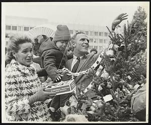 Mayor and Mrs. Kevin White and son, Christopher, decorate Christmas tree at City Hall Plaza.