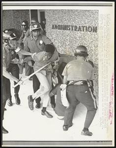 Riot police remove students from administration building after the students had taken over the building at predominantly black Florida Memorial College. The students refused to leave the building and the police had to be called in.