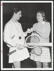 Friendly Greetings are exchanged between Mrs. Mildred Johnson (left) of Boston and Mrs. William Saylor of Needham. They're competing in the national women's indoor tennis championships at Longwood Cricket Club, Brookline.