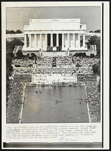 The Festivities Begin-- This was the scene as a religious and patriotic program at the Lincoln Memorial opened Honor America Day in Washington this fourth of July. Some persons are in the shallow reflecting Pool in foreground. This picture was made from atop the Washington Monument with a long lens camera.