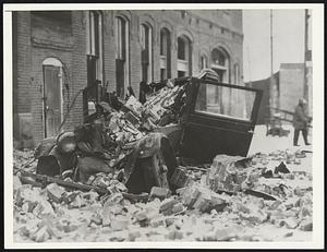 This auto happily was unoccupied when bricks from a building near which it was parked showered down upon it during the lastest severe earthquake at Helena, Mont. It was the second [illegible] [ea]rthquakes among hundreds that caused this city to tremble during the past three weeks, killed [illegible] of persons, and caused thousands of dollars worth of damage.