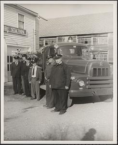 Marshall Pease, Morris Dwight, Sam Puchalski and Eugene N. Graves standing by a fire engine