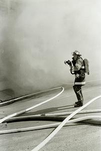 Chelsea firefighter Robert Cameron donning his SCBA