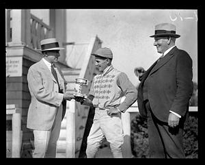 Jockey being given a cup