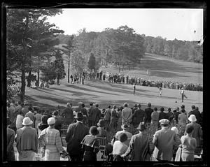 A crowd watching golf