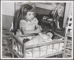 Donna Marie Noe tucks in her dolly at grandma's home