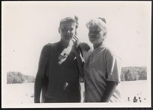 Two young women standing in the sunlight