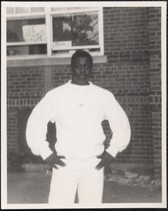 Young man posing with hands on hips