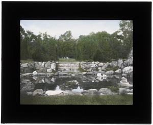 Rustic natural stone wall surrounding pool