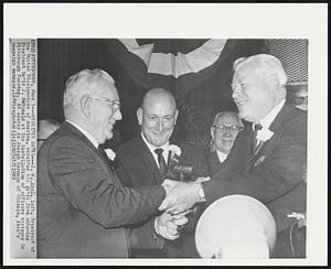 Receives Gavel-- I.W. Abel, left, President of the United Steelworkers of America, receives his gavel from outgoing President David J. McDonald at the installation of officers ceremony in Pittsburgh Tuesday. At center is Joseph Germano of Chicago, Abel's campaign manager.