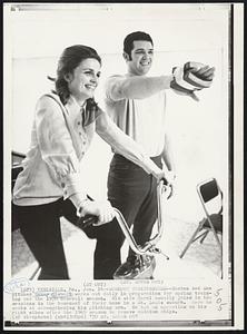 Workout Togetherness--Boxton Red Sox pitcher Sonny Siebert works out daily in preparation for spring training and the 1970 baseball season. His wife Carol usually joins in the sessions in the basement of their home in a St. Louis suburb. Here here works at strengthening his pitching arm. He had an operation on his right elbow after the 1969 season to remove calcium chips.