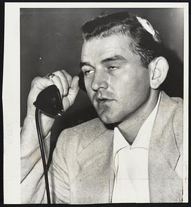Still Groggy, Charles Silvera calls Manager Casey Stengel of the New York Yankees to report on the head injury which required several stitches to close. Charley was accidentally hit on the head when Les Moss of the St. Louis Browns missed a strike in the game Tuesday night.