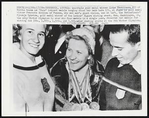 Quadruple gold medal winner Lidia Skoblikova (C) of Russia beams as "fans" inspect medals hanging about her neck here 2/2. At right is gold medal winner Francois Bonlieu of France, who won men's giant slalom, and at left, the Netherlands' Sjoukje Dykstra, gold medal winner of the ladies' figure skating event. Mrs. Skoblikova, 24, the only Winter Olympian to ever win four medals in a single year, received her medals for winning the 500-, 1,000-, 1,500-, and 3,000-meter skating events at the 9th Winter Olympics.