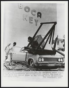 The emergency water supply tank of a Ft. Lauderdale oceanfront hotel smashed the hood of a car as it was jarred loose by the driving winds of hurricane Cleo early 8/27.