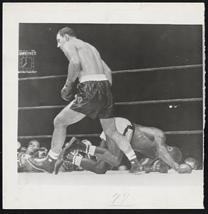 Retaining His Crown, Heavyweight Champion Rocky Marciano heads for neutral corner after knocking out Challenger Ezzard Charles in 2:36 of the eight round in their scheduled 15-round championship battle at Yankee Stadium.