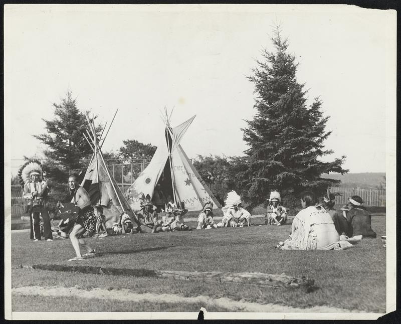 Old Indian Rites Revived at Tribal Ceremonies. A young brave is shown stamping the bow and arrow dance during inter-tribal ceremonies of the Passamoquoddy and Penobscot tribes at Orono, Me., July 23. Gayly colored feathers and blankets made the ceremonies brilliant spectacle.