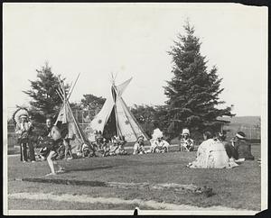 Old Indian Rites Revived at Tribal Ceremonies. A young brave is shown stamping the bow and arrow dance during inter-tribal ceremonies of the Passamoquoddy and Penobscot tribes at Orono, Me., July 23. Gayly colored feathers and blankets made the ceremonies brilliant spectacle.