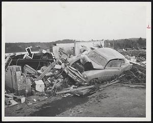 Ravaged by Tornado-Pictures of the houses destroyed in the Winthrop Oaks section of Holden show the hit and miss pattern the tornado followed in destroying these houses. Top photo shows a Main St. gas station demolished. Attendant greasing a car, shown by arrow, miraculously escaped death.