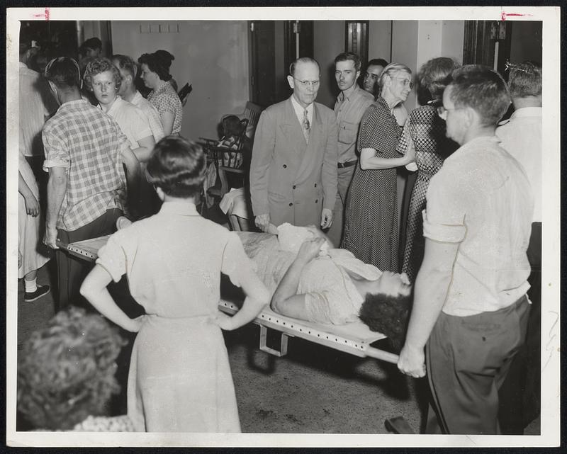 Bringing in the Injured-Bystanders show concern and sympathy as another tornado victim is brought in for treatment. Many came to the hospitals in hope of getting news of missing relatives.