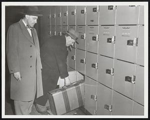 So. Sta. Lockers L-R Hal Neuhoff watches a customer Michael Becker of Rox. Place a suit case in locker