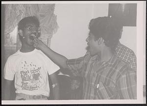 Young man feeding a friend