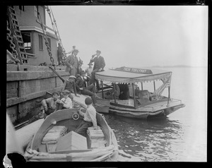 Boat with sign "Fresh Fish and Fruit" delivers bottled drinks to men on pier (possibly Prohibition selling illegal alcohol)