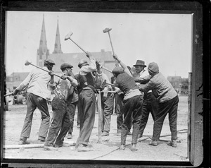 Workers pound in the tent poles when the circus comes to town