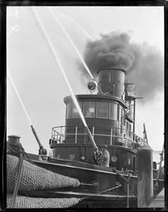 Fireboat Matthew J. Boyle firing water guns, tug