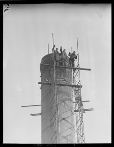 Men climbing smokestack