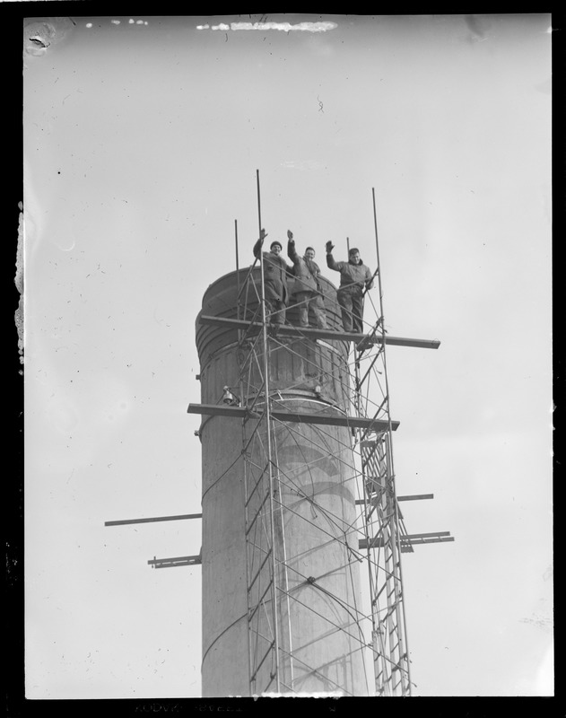 Men climbing smokestack