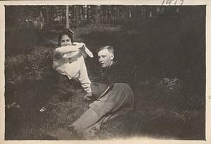 Albert T. Chase in uniform and unidentified woman lying on grass