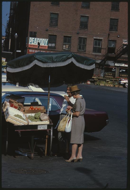 People at produce stand by side of car