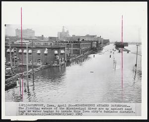 Mississippi Attacks Davenport--The flooding waters of the Mississippi River are up against sand bags was water begins to invade this Iowa city's business district.