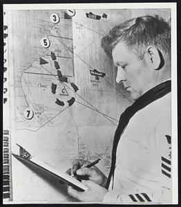 QM 1/C Allan E. Thacker, Assistant Duty Officer at Norfolk, Va., Coast Guard Office, Checks Course of Hurricane Connie on Wall Map. Hurricane is Still of Florida Coast.