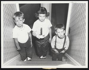 Off to Bed by candlelight march Billy, Judy and Stephen Donovan of 153 Waverly Ave., Melrose. They didn't mind the lack of lights - except in the television picture tube.