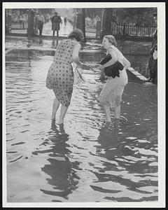 Two women in flooded street
