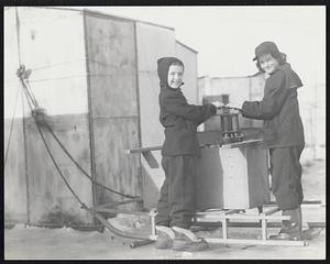 Warming their hands during outdoor fishing are Betsy Cook and Sandra Halperin of Rowley.