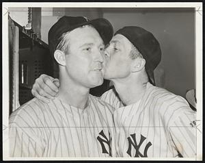 Definitely proving those hard-hearted New York Yankees can be as human as the next fellow, Catcher Bill Dickey plants a real home-run smack on the cheek of his battery mate, Charlie Ruffing, during the celebration which broke loose in the dressing room after the series triumph. Bill caught all four games while Charlie hurled two of the four victories.