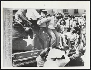 Philadelphia -- Police Come To Aid Of Army -- Students at Temple University were holding a Indo-China moratorium rally when this Army tank had an accident with a passenger car. The students then climb aboard the tank and had to be cleared off by Philadelphia police. There were no arrests.