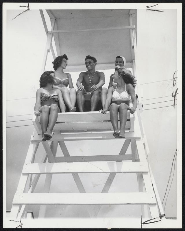 Work, They Call It-That man in the middle is technically at work guarding lives at Carolina Beach, N. C. He'd better yell for help himself; all four girls have their eyes on him.